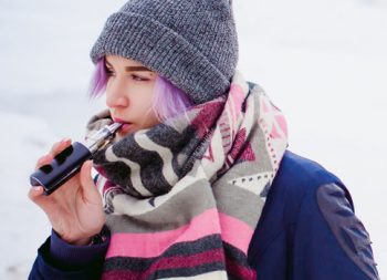 Young girl smoking an e-cigarette