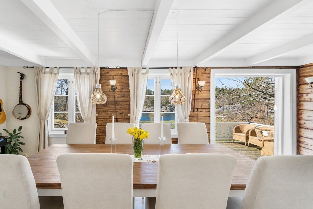 Living room with old, original timber walls in the farmhouse. This is only one of the old detalis making this beach property so unique. 